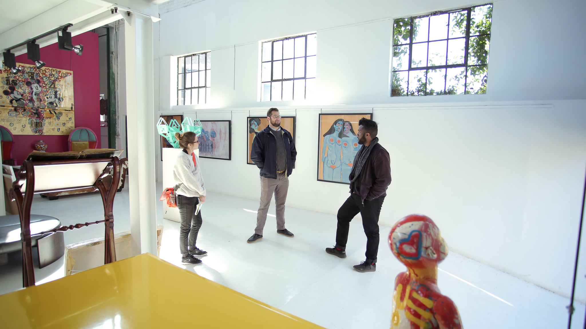 Students and program manager in gallery