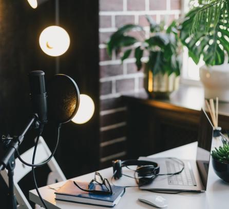 Desk setup with professional equipment for recording a podcast