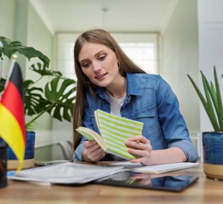 Student reading book at desk