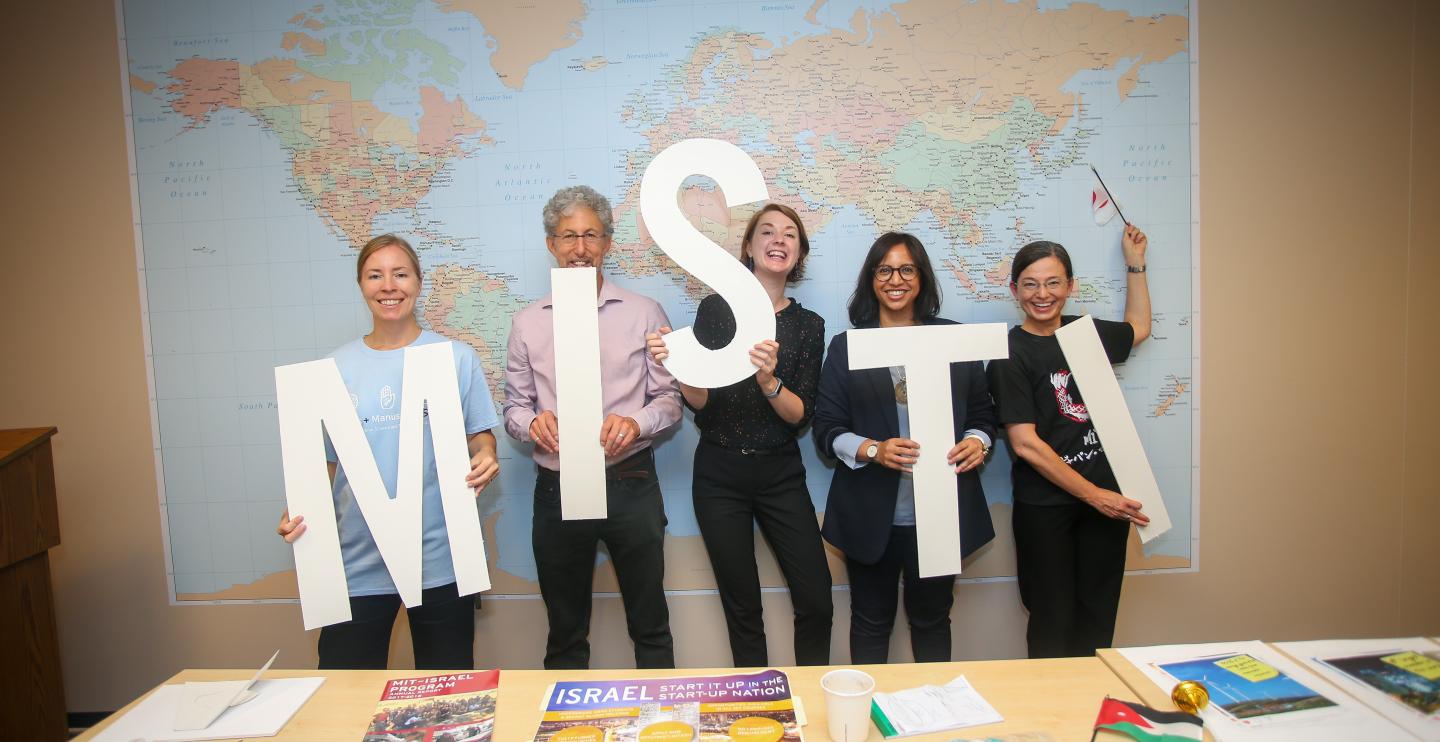 MISTI staff with signs