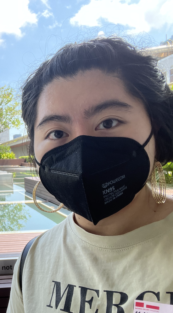 Gabrielle Liu selfie with a pond behind her and in a distant, the skyline of Singapore