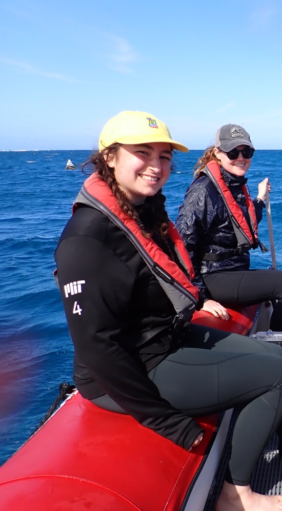 Annemarie Dapoz seated with 3 others on red speedboat out in the ocean of Queensland, Australia