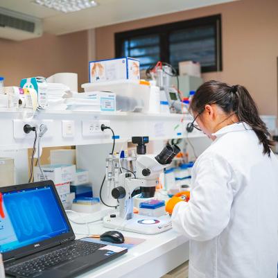 student looking through microscope in lab in France