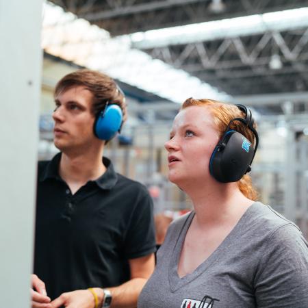 Student and host working in factory lab