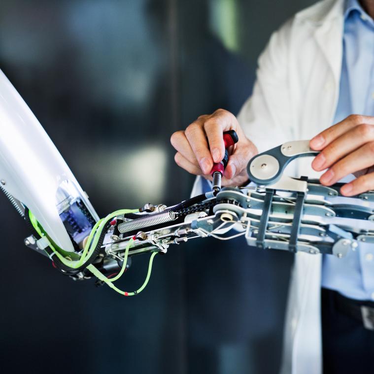 engineer working on robotic arm