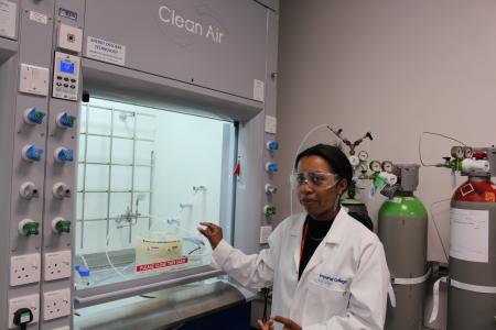 Student in lab next to machinery