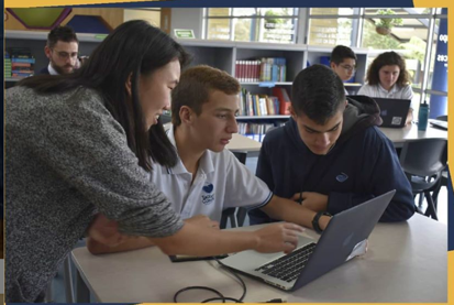 Erica teaching students in library in Colombia